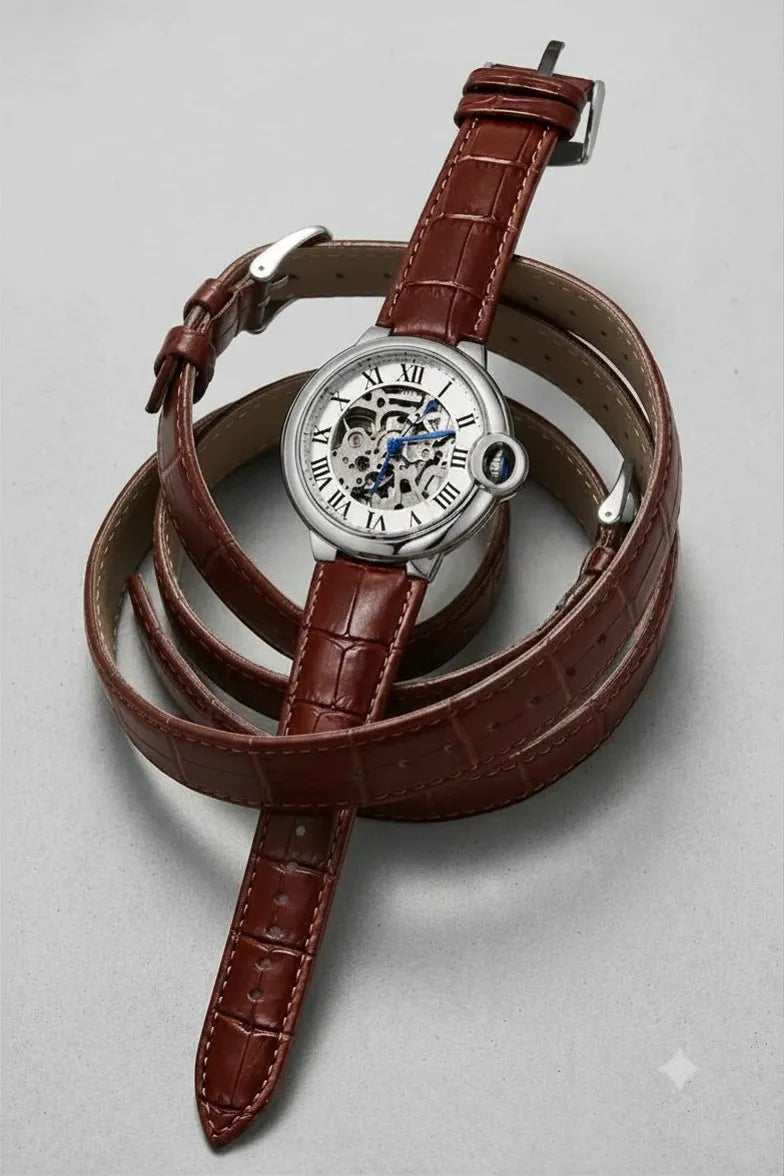 Classic silver skeleton dial men's watch with brown leather strap.
