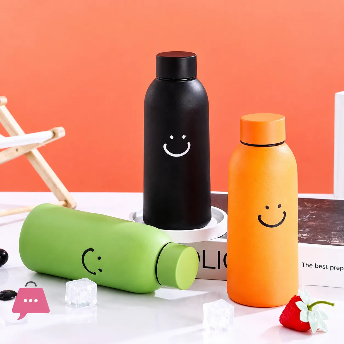 Colorful glass insulated smiley face water bottles on a marble kitchen counter