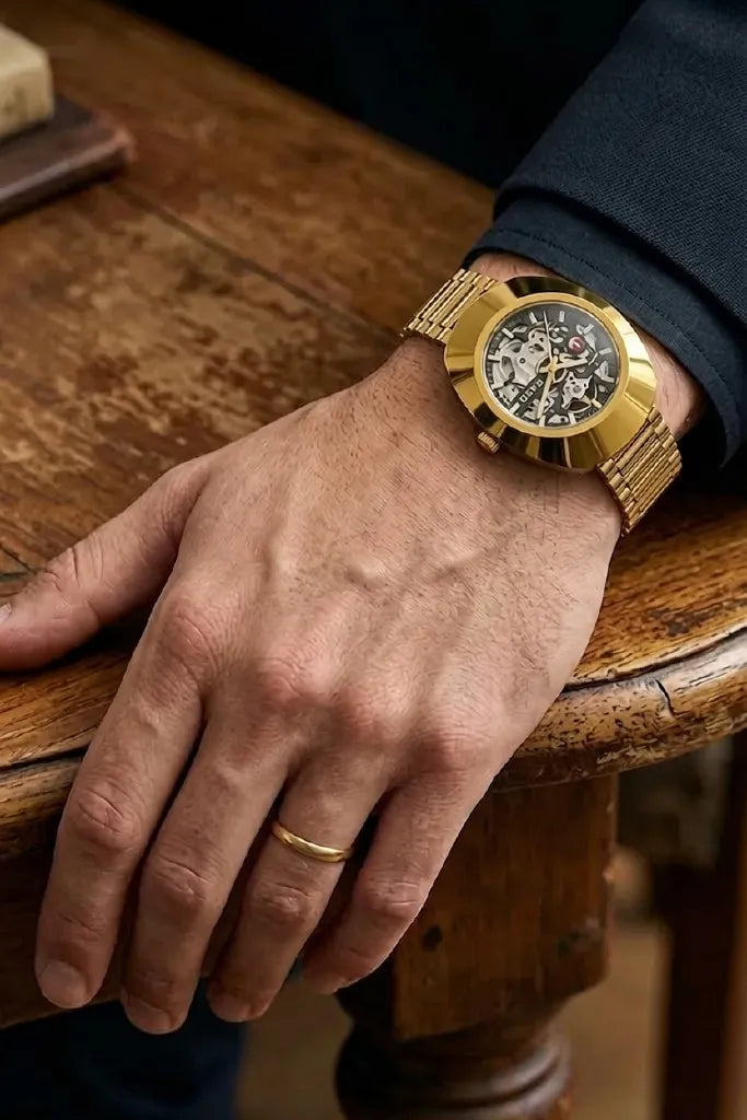 Luxury gold skeleton-style men's wrist watch with stainless steel bracelet.
