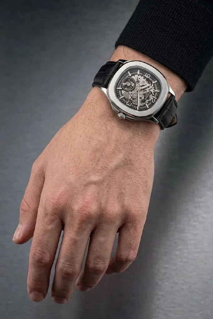 Luxury black skeleton dial men's watch with leather strap.
