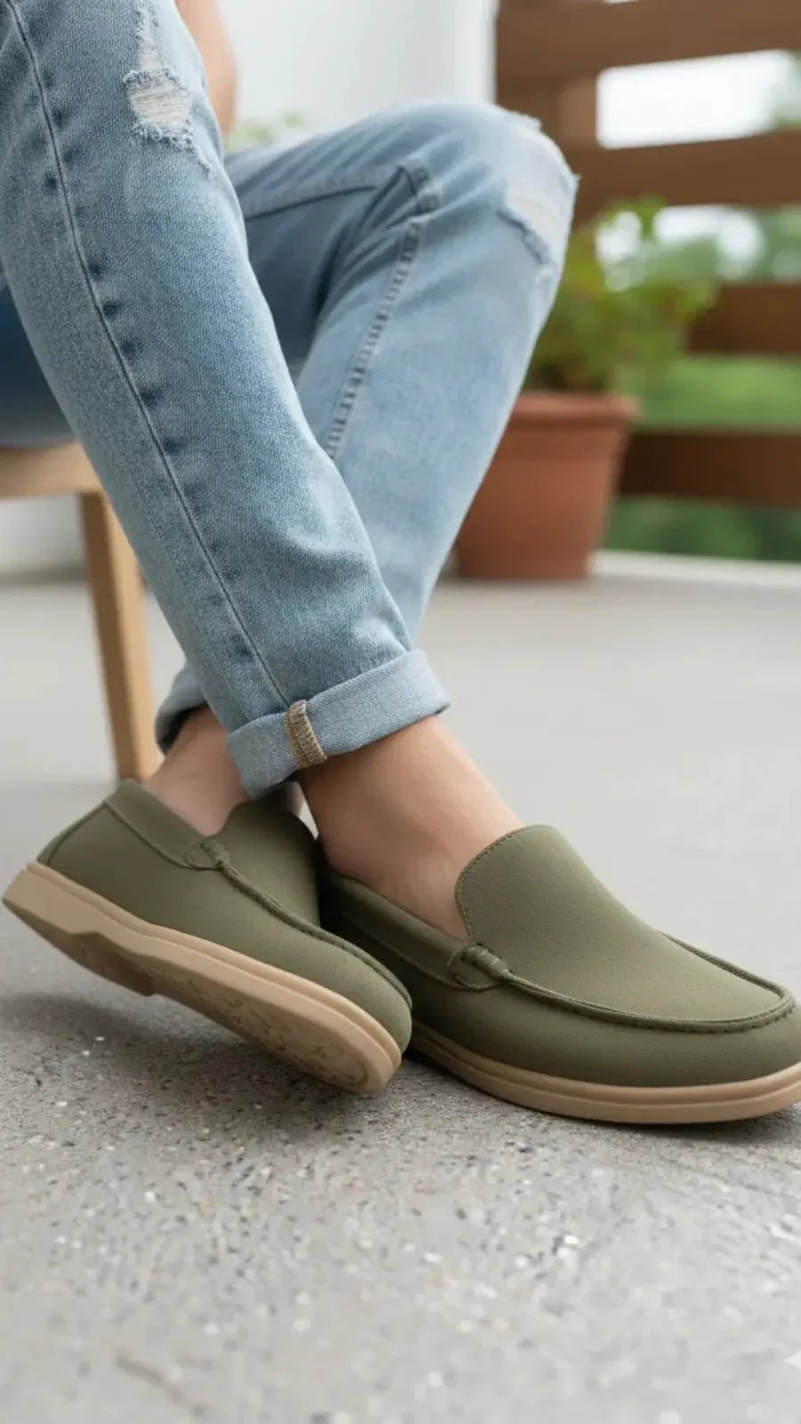 Men's olive green suede leather loafers with lightweight slip-on design.
