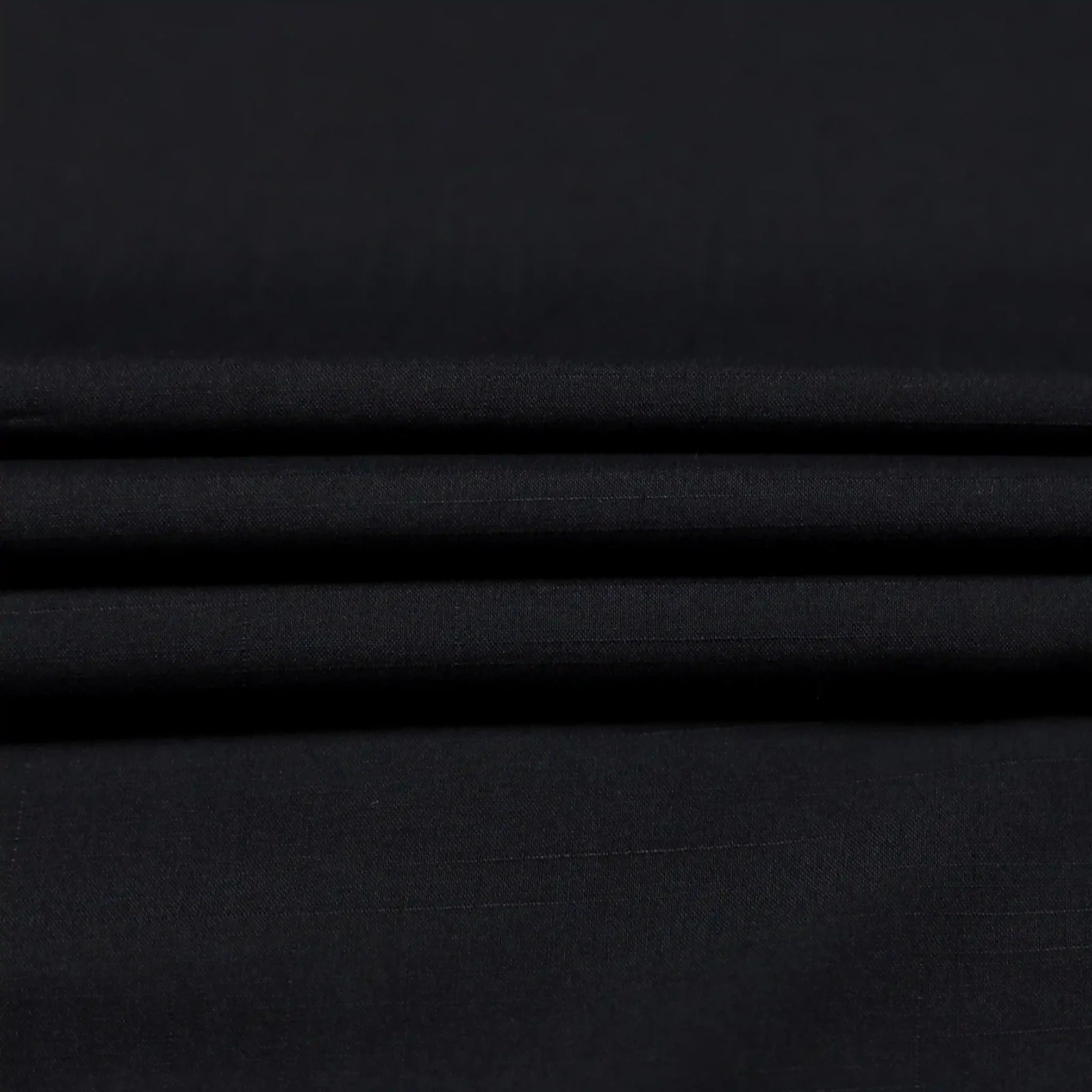 Premium black wash and wear fabric for men's formal wear.
